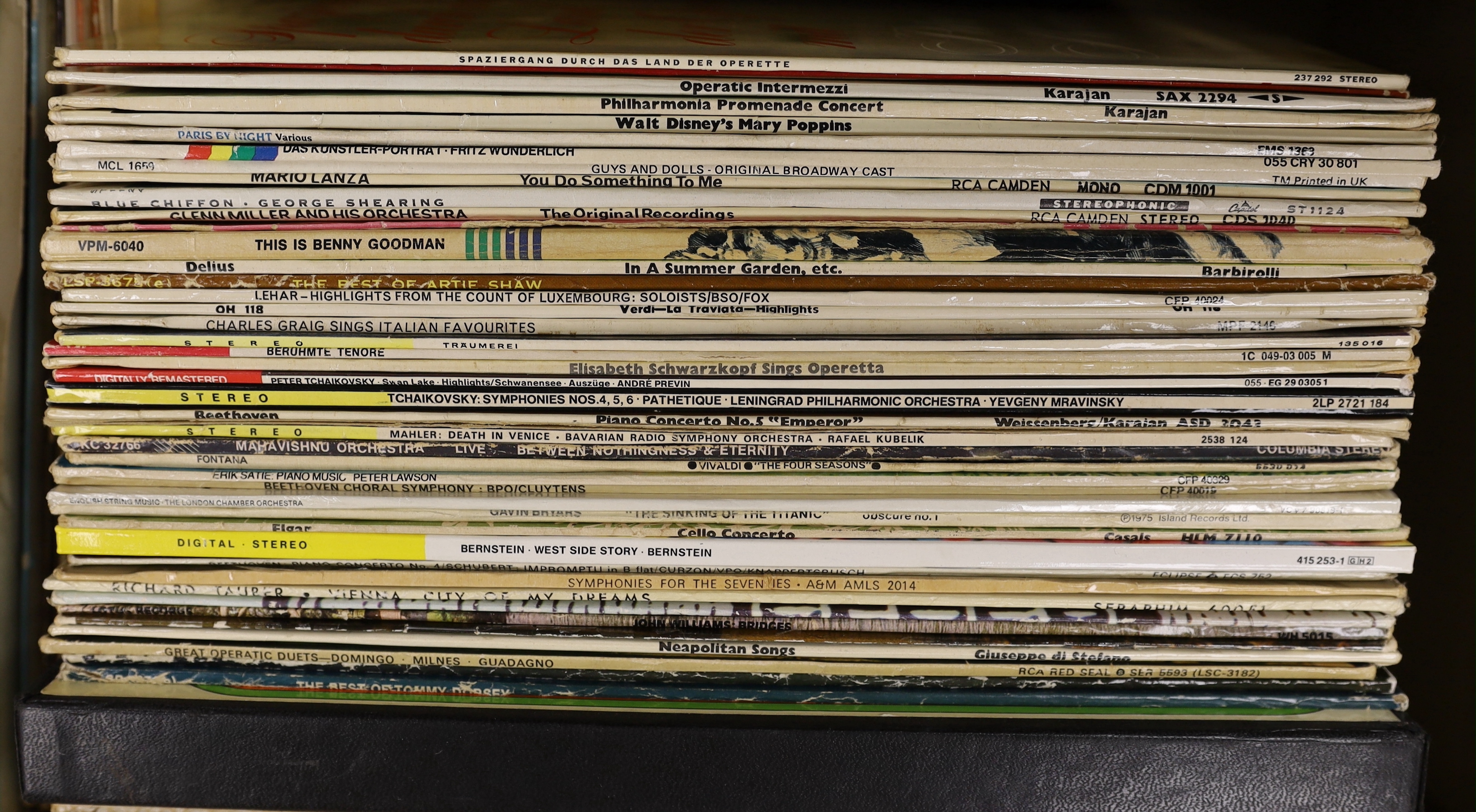 A collection of jazz and classical LPs, including Charlie Parker, Louis Armstrong, Glenn Miller, Perry Como, Artie Shaw, André Previn, Leonard Bernstein, Duke Ellington, Benny Goodman, plus some recordings of operas and